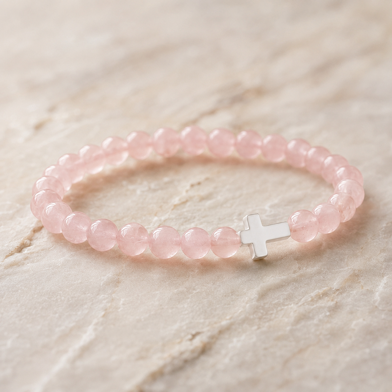 Pulsera de cuarzo rosa con cruz incluida en el Pack Marta y María